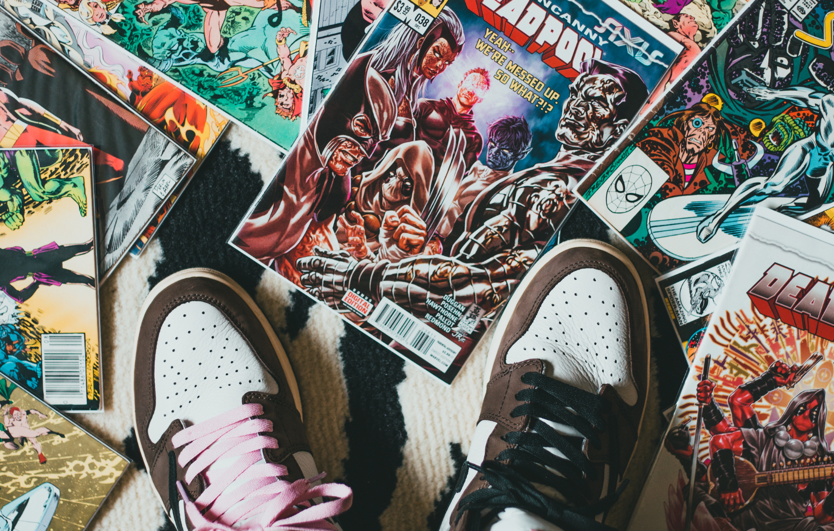 comics laying on the floor with shoes in view