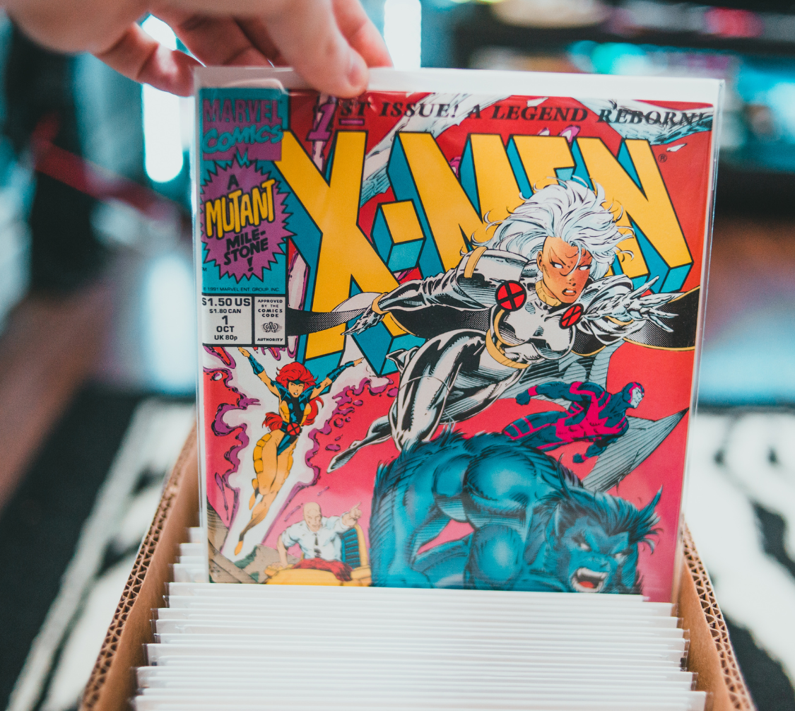 A comic short box with x-men 1 being pulled out of it